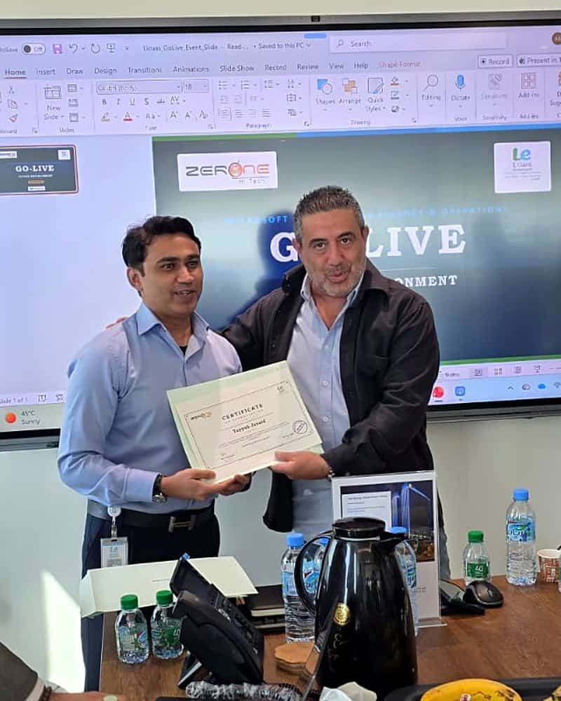 Zerone HiTech and Licuas Environment Qatar team members with the Microsoft Dynamics 365 project completion certificate
